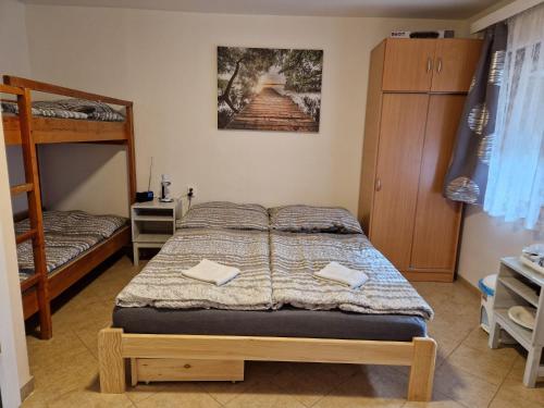 a bedroom with a bed and a bunk bed at Chatky U Davida Máchovo jezero in Doksy