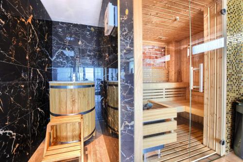 a sauna with wooden walls and a glass wall at Santa Angela Solina Resort & SPA in Solina