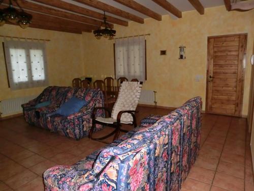 a living room with two couches and a chair at El Establo,Casa rural in Busto de Bureba
