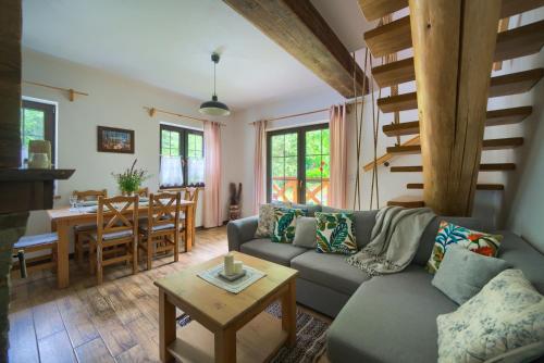 a living room with a couch and a table at Tarninowe Wzgórze in Kunkowa