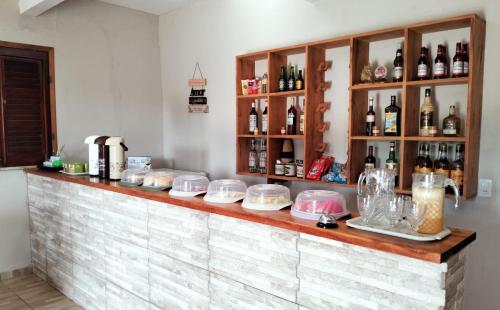 a counter in a room with bottles of alcohol at Pousada Villa Marini in Itarema
