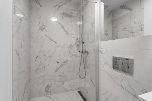 a bathroom with a shower with a glass door at Klettar - The Old Hatchery Iceland in Fludir