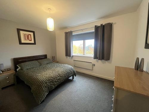 a bedroom with a bed and a window at Deluxe Large Apartment Opposite Hepworth Gallery in Wakefield