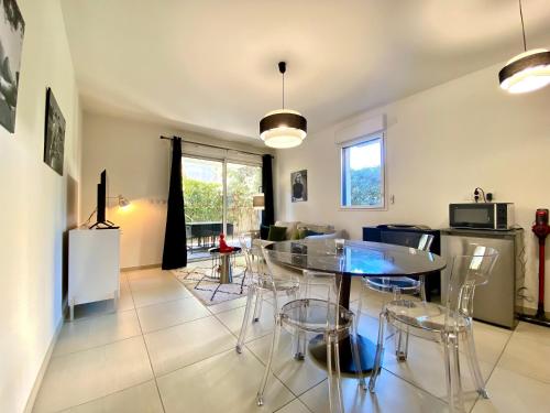 une cuisine et une salle à manger avec une table et des chaises dans l'établissement Le Pearl By SCLS Locations, à Cannes