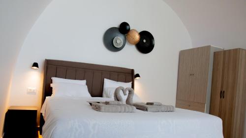 a bedroom with a bed with towels on it at La Vista Santorini in Fira