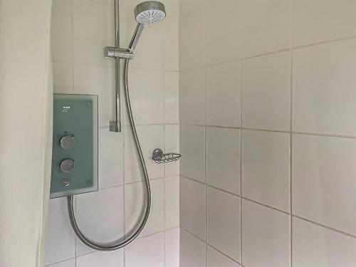 a shower with a shower head in a bathroom at Edgecoombe in Shaftesbury