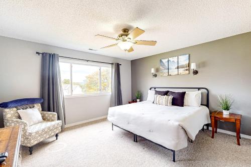 a bedroom with a bed and a chair and a window at Sunrise Pointe in Branson