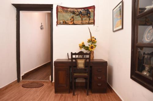 a room with a desk with a chair and a painting at 4BHK Private Pool villa in North Goa with Kayaking nearby!! in Moira