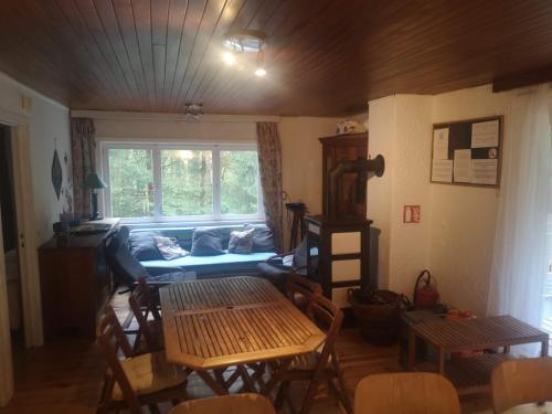 a living room with a couch and a table at Chalet - Au retour vers Soi in Les Nobertins