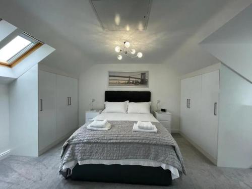 - une chambre avec un grand lit et des placards blancs dans l'établissement Sophisticated & Contemporary Modern House for 6 Pass the Keys, à Chapel-en-le-Frith