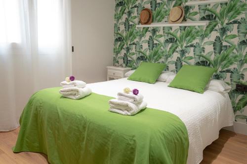 a bedroom with a bed with towels on it at Zenete Terral Málaga in Málaga