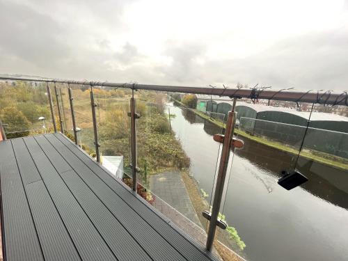 a view of a river from the balcony of a building at Deluxe Large Apartment Opposite Hepworth Gallery in Wakefield