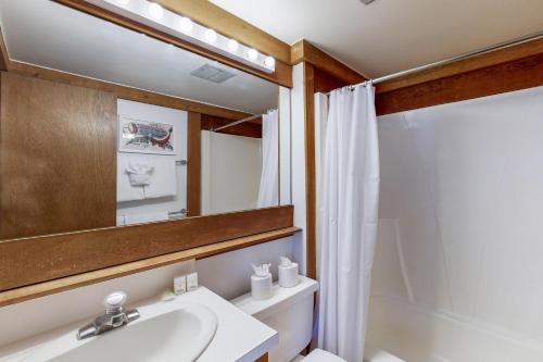 a bathroom with a sink and a mirror and a tub at Great Northstar Condo in Kingswood Estates