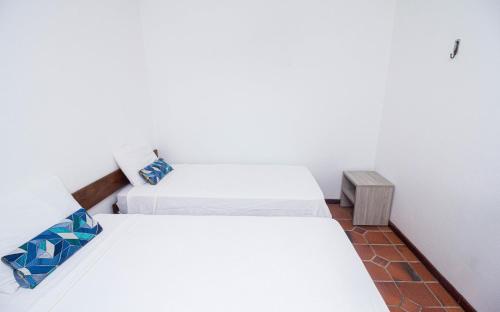 a room with two beds and a night stand at Arrey Rio Poty Hotel in Luis Correia
