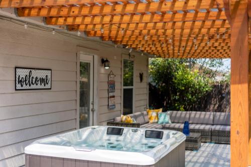 una bañera de hidromasaje en un patio con pérgola en Luxury Oasis Hot-tub, Games & Bbq By Fiesta Tx en San Antonio