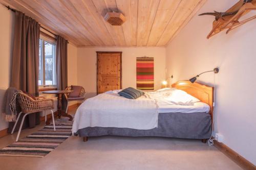 a bedroom with a bed with a wooden ceiling at Kalix Riverside inn in Kalix