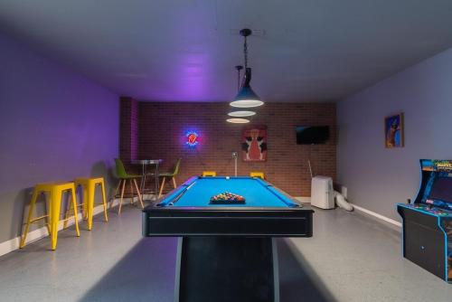 a room with a pool table in the middle of it at Luxury 5br House With Pool By Seaworld & Lackland in San Antonio