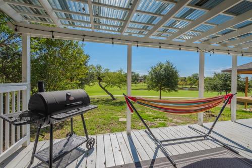 a hammock on a porch with a bbqarmaarmaarmaarmaarma at Stunning Deck, Hot-tub View To Lake & Golf Course in San Antonio