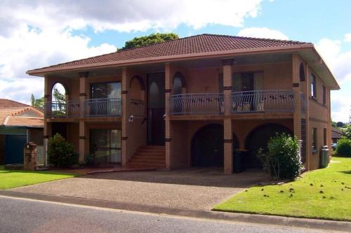 a large house with a balcony on a street at Aspley bedroom & share bathroom with other guests in Brisbane