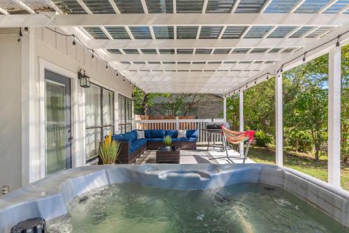 an outdoor hot tub on a patio with a pergola at Stunning Deck, Hot-tub View To Lake & Golf Course in San Antonio