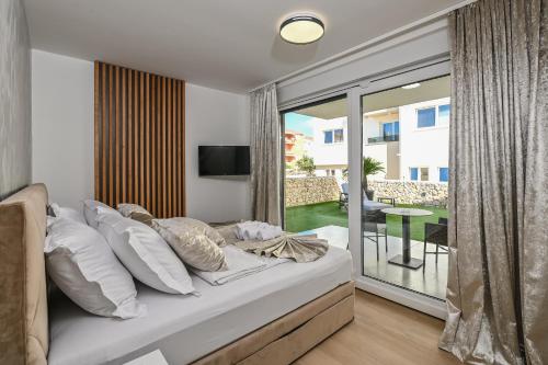 a bedroom with a bed and a sliding glass door at Luxury Villas Great Escape & Noa in Novalja