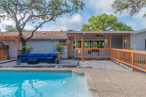 a home with a swimming pool and a house at Luxury House By Fiesta Texas & Seaworld With Pool in San Antonio