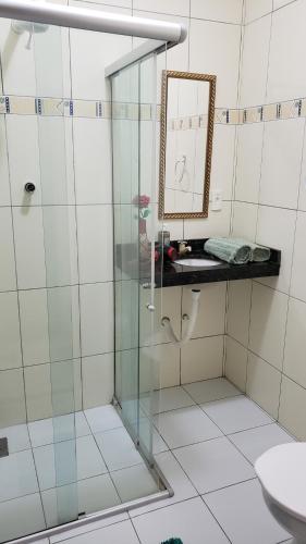 a bathroom with a shower with a mirror and a sink at Casanostra44 in Jenipabu