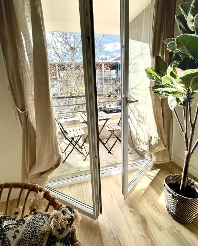 a room with a sliding glass door with a potted plant at Modern 1 Bdr + Balcony + Free Parking + AC + Pool in LʼIsle-dʼAbeau