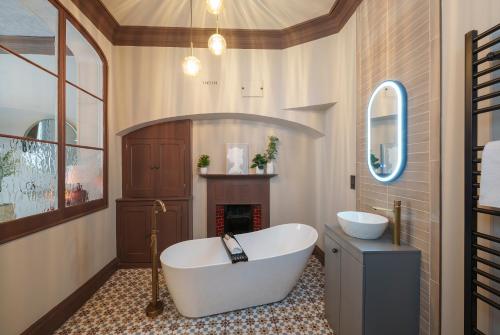 a bathroom with a large tub and a fireplace at The Florin - 1 Bedroom Apartment in Central Bristol by Mint Stays in Bristol