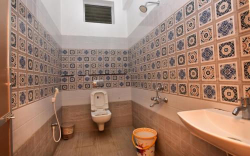 a bathroom with a toilet and a sink at Villa D Jems -A Heritage Home stay in Puducherry