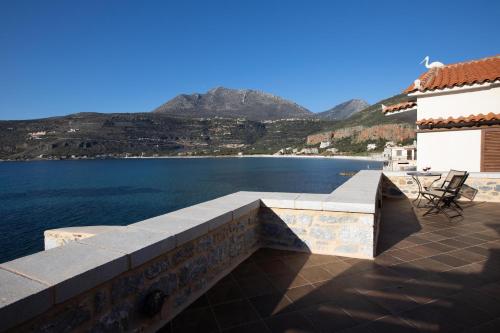 a patio with a view of a body of water at Sun Villa in Neon Oitilon