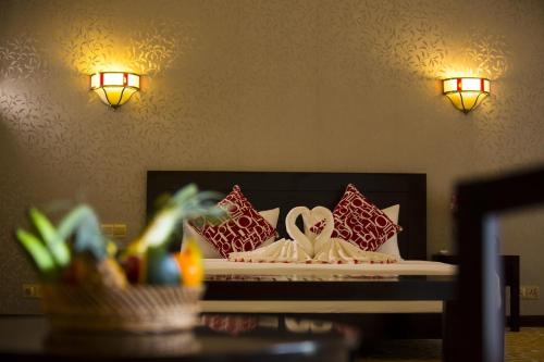 a hotel room with a bed with pillows on it at Grand Tamarind Lake in Kataragama