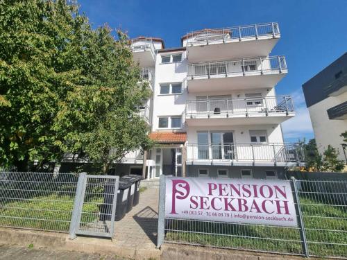 a sign on a fence in front of a building at Pension Seckbach in Frankfurt/Main