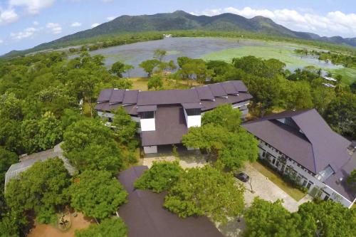 an overhead view of a building with trees and a lake at Grand Tamarind Lake in Kataragama