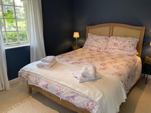 a bedroom with a bed with towels on it at Little Crugsillick in Veryan