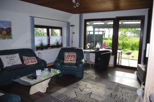 a living room with two chairs and a table at Ferienhaus Mitteldeich in Butjadingen