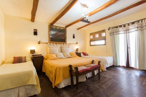 a bedroom with two beds in a room at La Posada del Rio in Tilcara