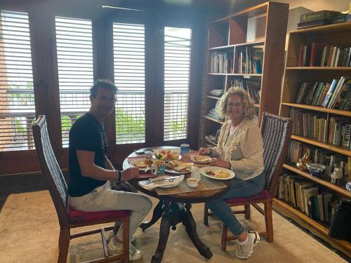 a man and woman sitting at a table eating food at Tranquility Estate in Kingston