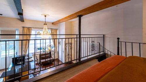a room with a balcony with a bed and a chandelier at Le Chouette Loft in Dijon