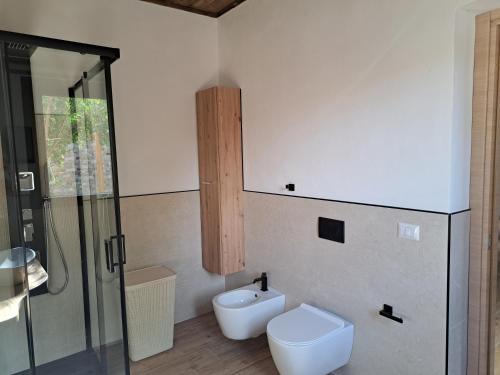 a bathroom with a toilet and a sink and a shower at Struttura Monte Olimpo in Porto Torres