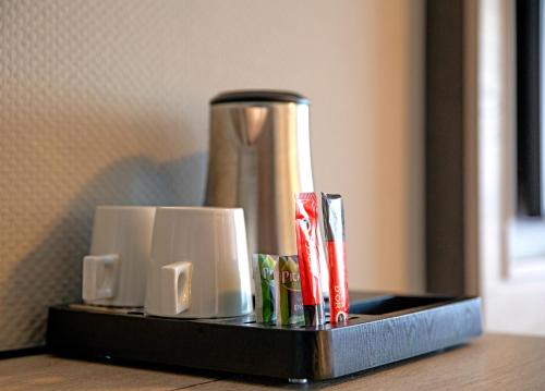 a black tray with a coffee pot on a table at Hotel Restaurant Eeserhof in Ees