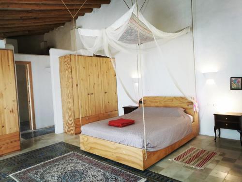 a bedroom with a bed with a swing at Milagro de Algar in Vejer de la Frontera
