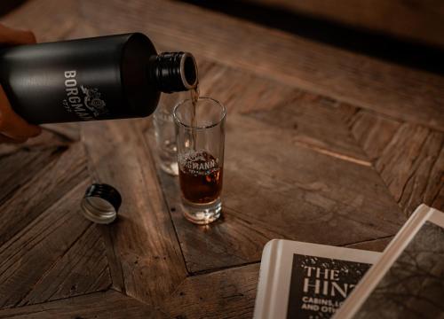 a drink being poured into a glass on a table at Berggasthaus & Lodge Resterhöhe in Mittersill