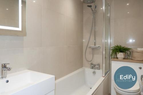 a bathroom with a shower and a toilet and a sink at Modernised House Close To City Centre in Southampton
