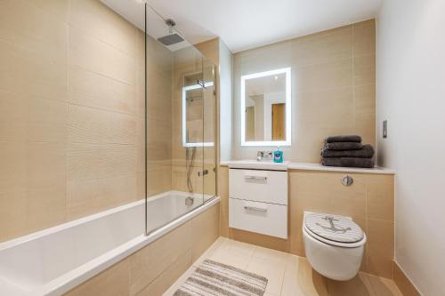 a bathroom with a toilet and a shower and a sink at Large Modern One Bedroom Apartment (nearly 800 ft) in London