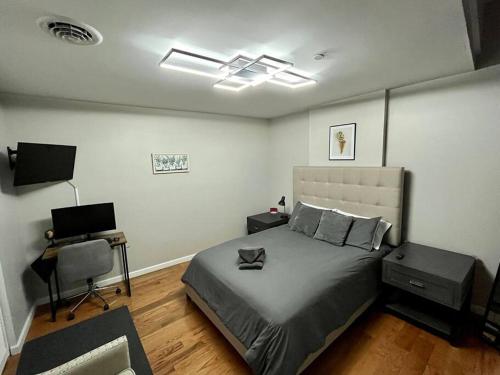 a bedroom with a bed and a desk with a laptop at Downtown Albany 1 Bed + Workstation @ Maiden Lane in Albany