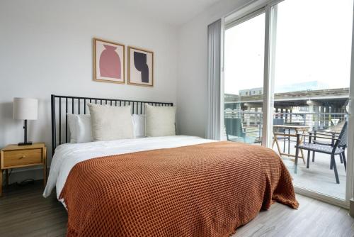 a bedroom with a bed with an orange blanket at Downtown 2br w gym deck nr Congress Ave ATX-212 in Austin
