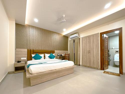 a bedroom with a large bed and a bathroom at Hotel Ananda Kashi in Varanasi