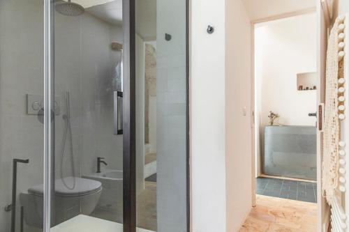 a bathroom with a shower and a toilet at Trulli Piovanello in Castellana Grotte