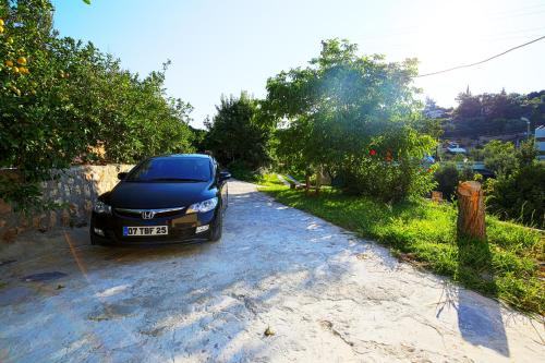 a car parked on the side of a road at Rose Hotel B&B in Patara